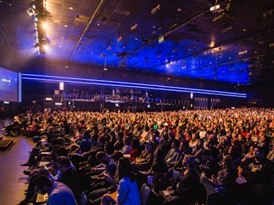 Large crowd at a lit-up conference or event venue