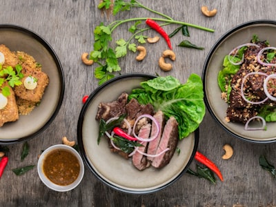 Plated dishes with steak, salad, and garnishes ready to serve